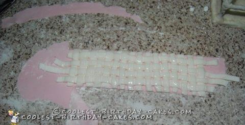 Weave 'glued' on to the baby pink fondant with water